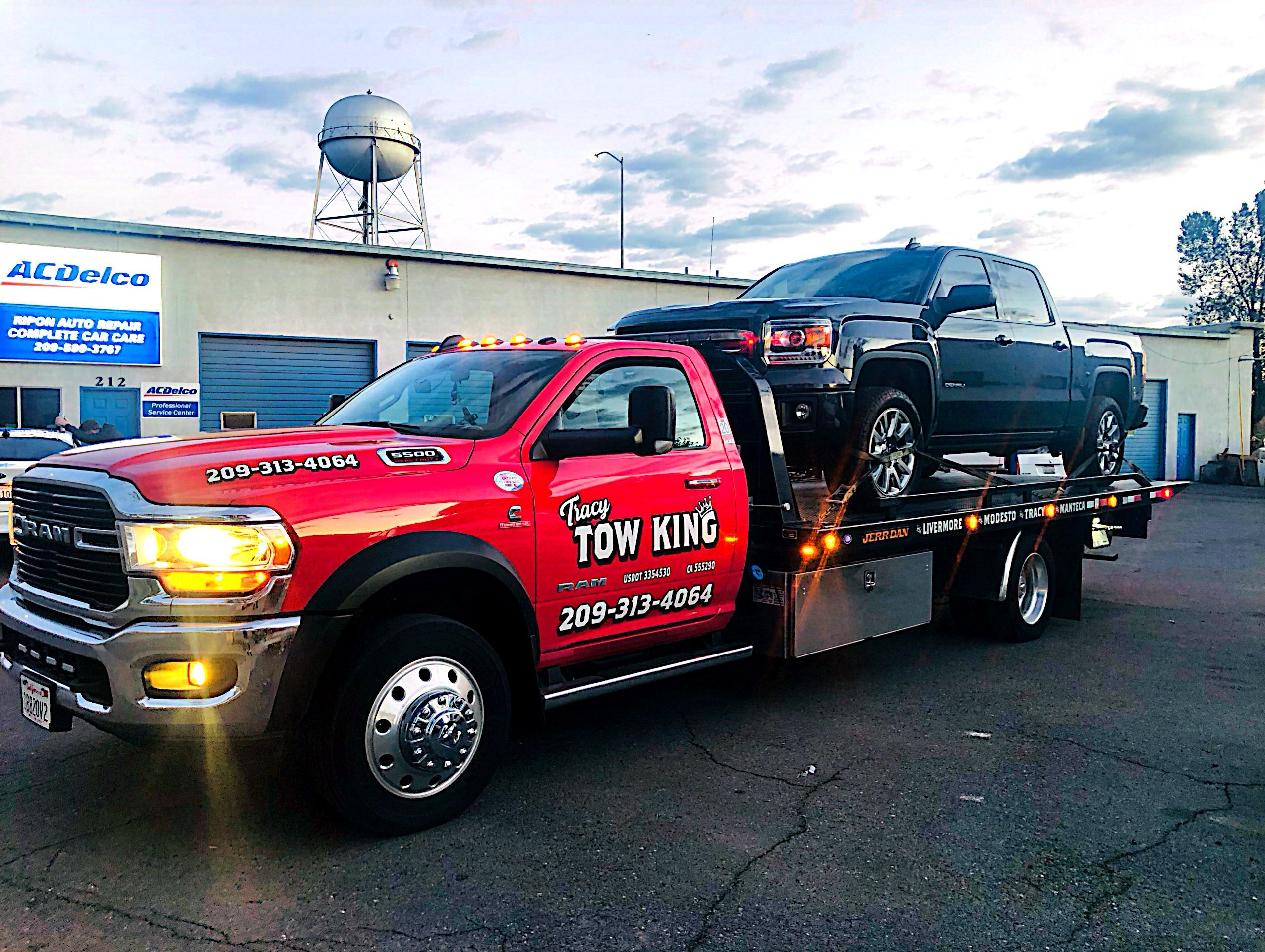 Tracy Tow King with a truck being towed