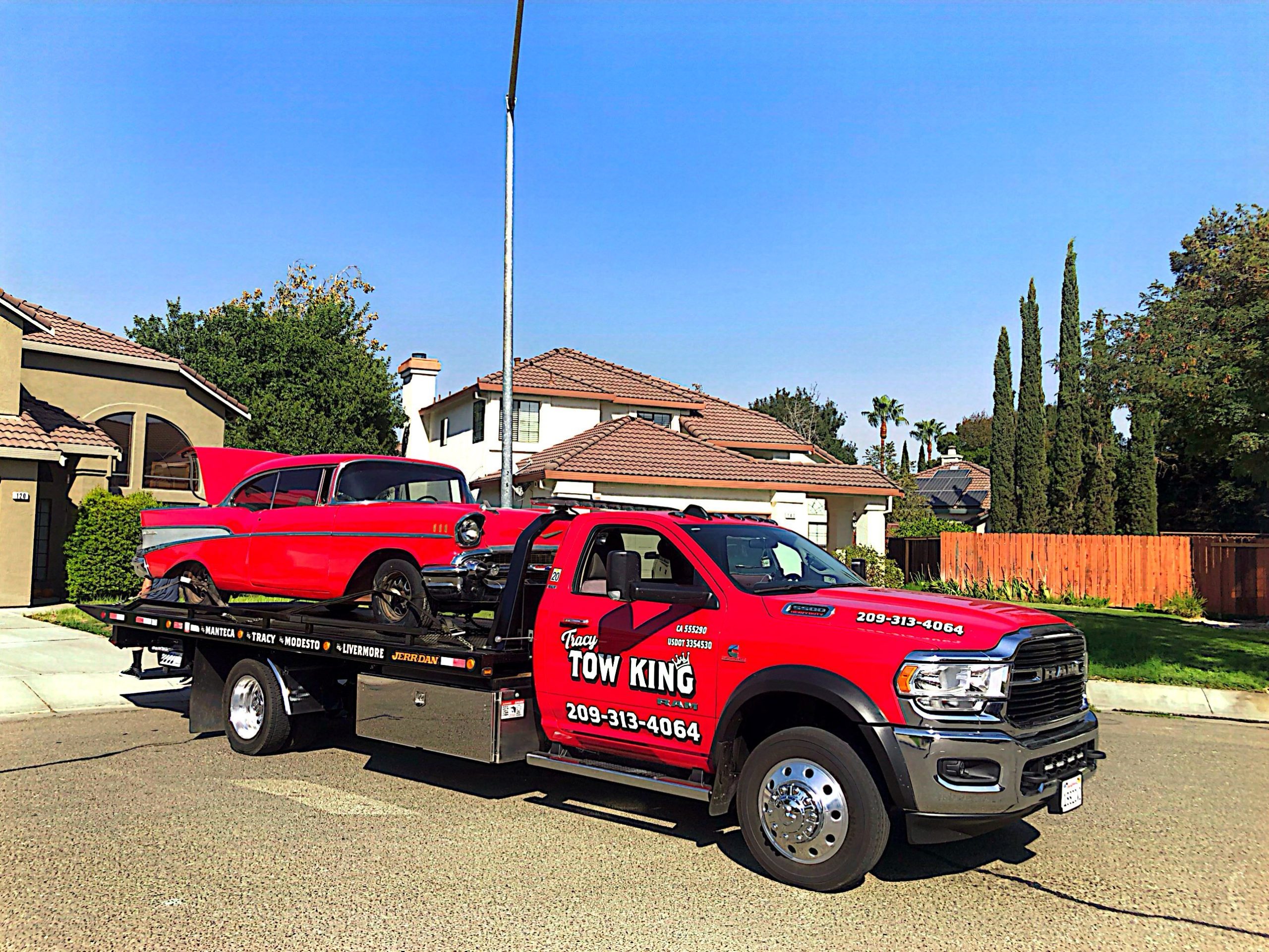 Tracy Tow King with a red vintage car on the back