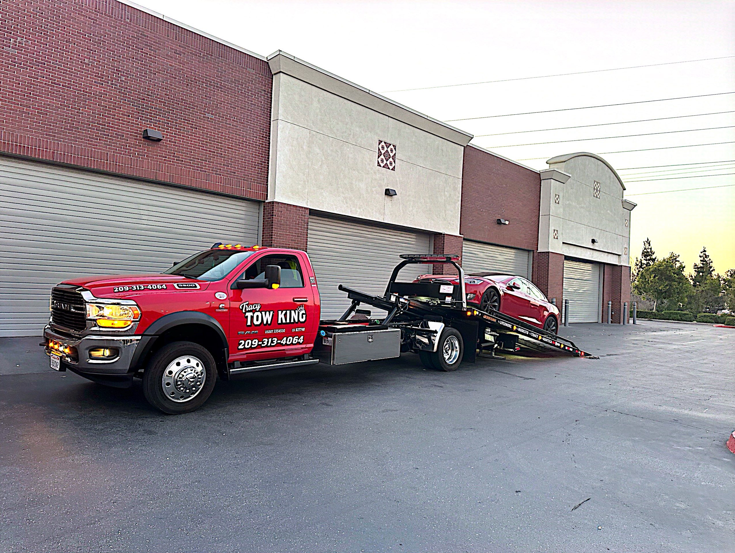 Tracy Tow King with a sports car on the tow truck